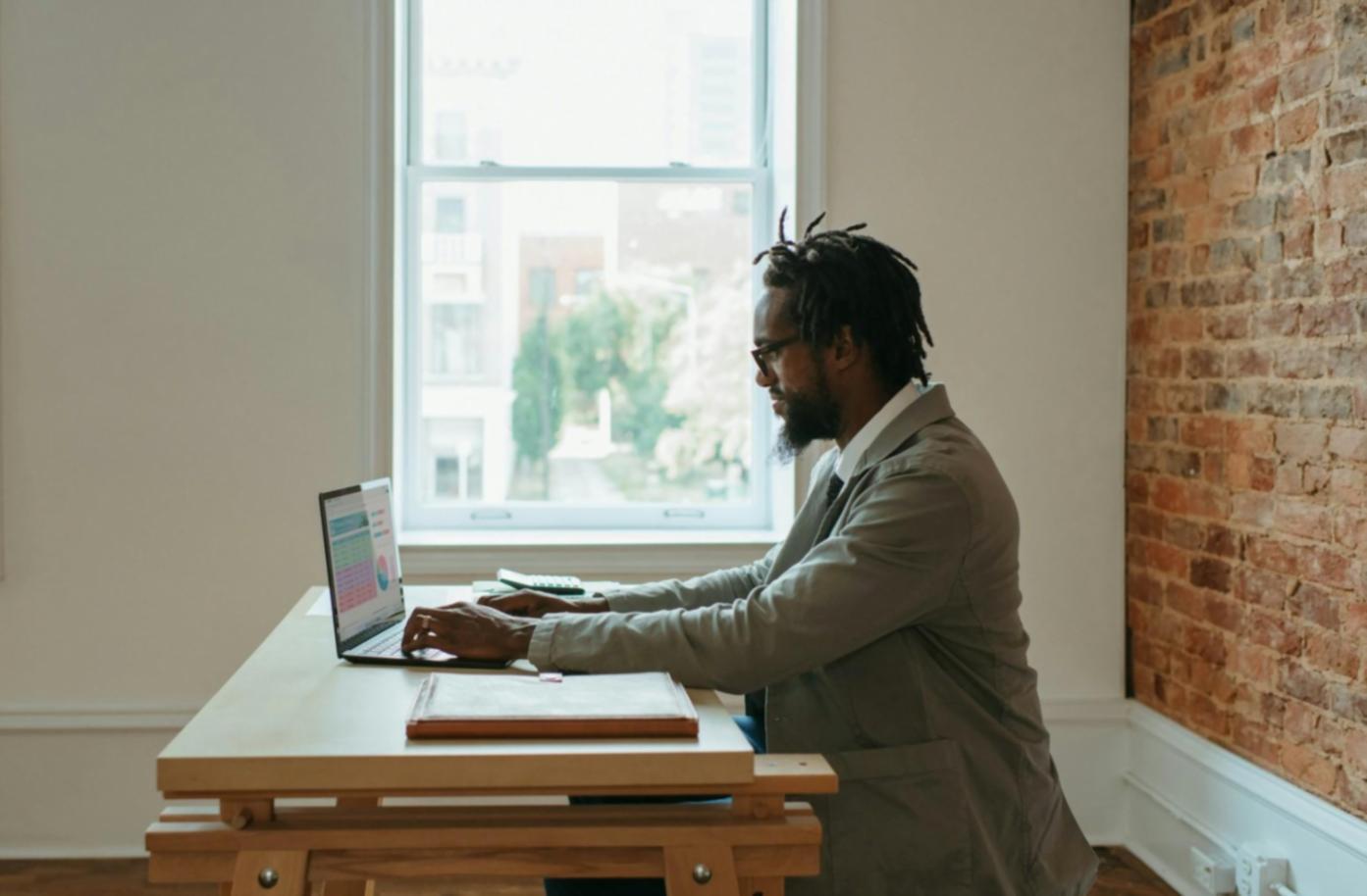 Person using budgeting tools and financial planning materials